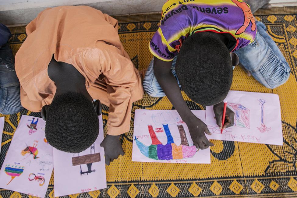 Children colouring at IOM's Multi-Purpose Community Hall in Yola, Adamawa state, Nigeria. Photo:  Natalie Oren/IOM 