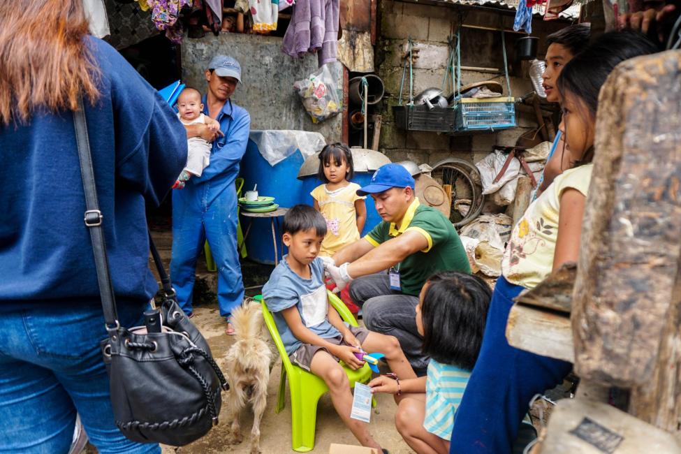 IOM has helped deliver much-needed measles and Japanese encephalitis vaccines to children in typhoon-hit communities in the Philippines. Photo: IOM/Andrea Empamano 
