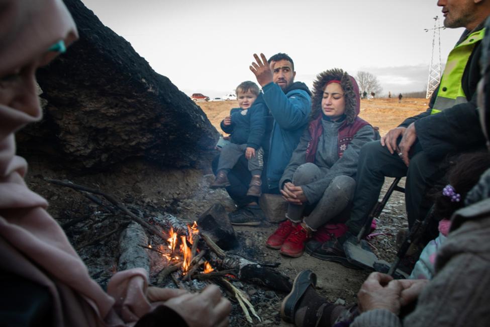 A Syrian family builds a fire after a failed crossing attempt at the Turkish border with Greece. Photo: Emrah Özesen/IOM 2020