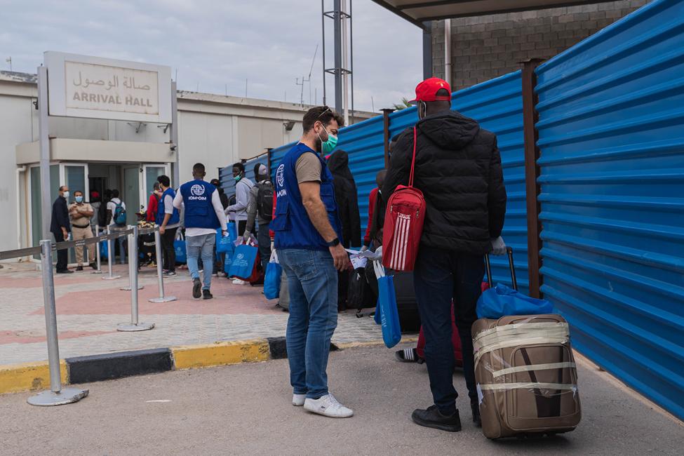 Migrants headed for the Gambian capital Banjul board a plane at Misrata International Airport after IOM’s Voluntary Humanitarian Return flights resumed from Libya. Photo: Moayad Zaghdani/IOM Libya  