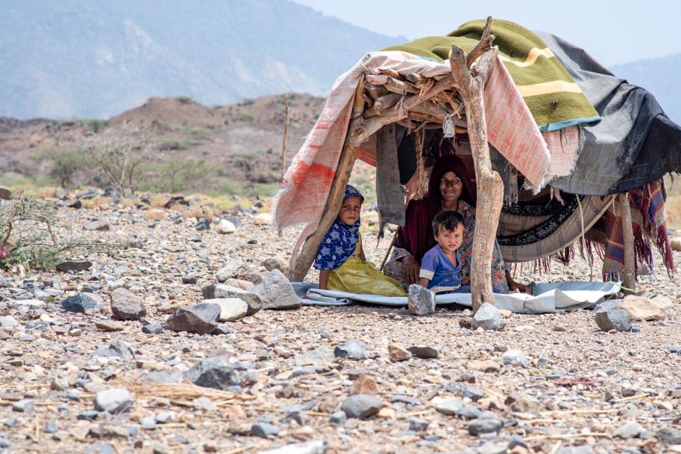 A displaced woman and her children in a makeshift shelter on the west coast of Yemen. Photo: IOM Yemen/Rami Ibrahim