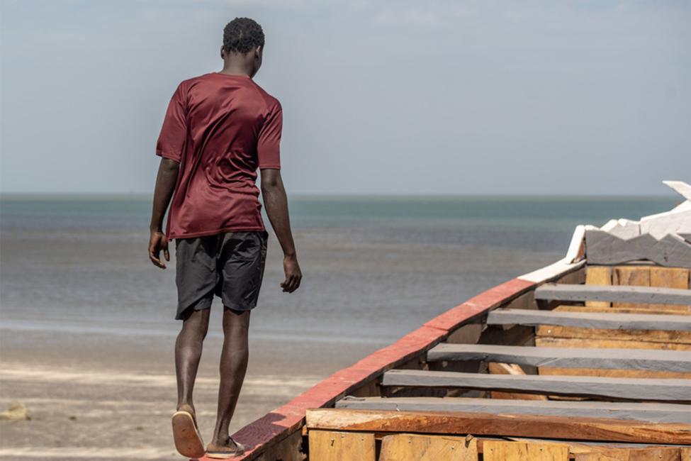 Sheikul narrates his migration experience while on an empty boat, similar to the one he traveled on. Photo: IOM/2021